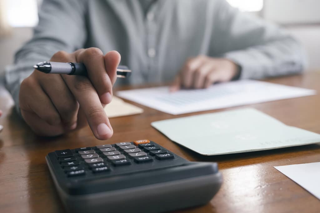 Finances Saving Economy concept. Male accountant or banker use calculator.